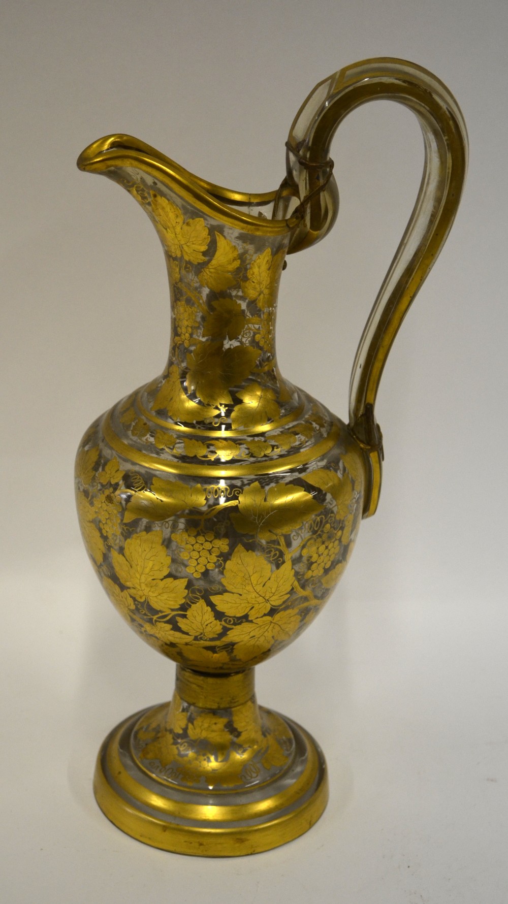 A 19th century continental glass wine ewer ornately decorated with fruit and vine, 40 cm h.
