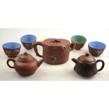 Three Yixing teapots, one incised with calligraphy to/w four tea bowls with glazed interiors (7)