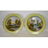 A pair of Victorian chargers each handpainted to the centre with a watery landscape by W. Thomas, 39
