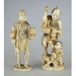 Two Japanese ivory Okimonos man and child selling fruit, 19 cm high, to/w a fisherman with rod and