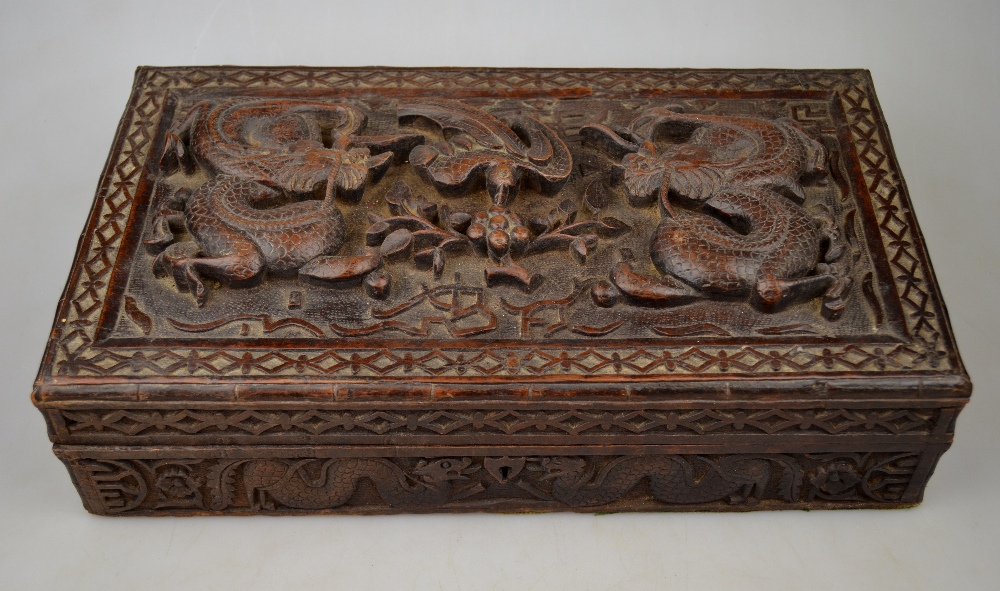 A Chinese carved teak cigar box, the top