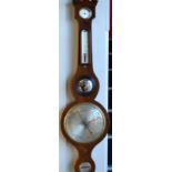 A Victorian satinwood edged mahogany wheel barometer having silvered dial and thermometer over a