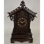 A late 19th century carved Black Forest cuckoo clock in the form of an alpine chalet, the eight-