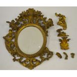 A 19th century giltwood Florentine wall mirror with carved and pierced foliate frame and oval