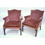 A pair of 19th century mahogany framed upholstered armchairs having arched backs over outsplayed