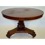 A Victorian rosewood breakfast table, the circular tilt top raised on a turned column with acanthus