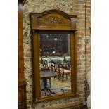 An antique French carved oak framed mirr