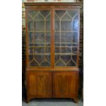 An early 20th oak desk, the moulded edge top over an arrangement of frieze drawers around a