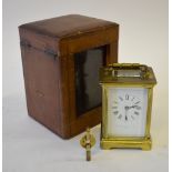 A brass carriage clock with enamel dial and bevelled glass panels, retailer Sir John Bennett Ltd.,