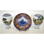 A pair of Chinese porcelain polychrome lamps, the spherical polychrome shades decorated with the