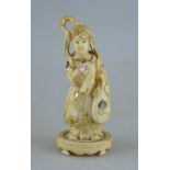 A Chinese carved ivory figure of a finely-dressed lady, her robe engraved and inlaid with abalone