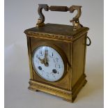 A gilt brass mantel clock with floral-de