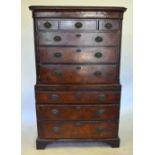 A George II feather-banded walnut oyster veneered chest on chest, having three short over three long