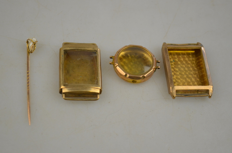 A 9ct gold pin set with a freshwater irregular pearl, to/w three 9ct gold wristwatch cases Condition