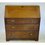 A George III oak bureau, the hinged fall