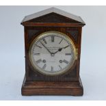 Camerer Kuss & Co, London, an oak cased eight-day two train mantel clock having a silvered dial,