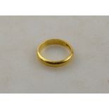 A 22ct yellow gold D-shaped wedding band with millgrain edge, size M,