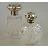 A Victorian square-cut glass scent bottle, the silver bun cover with floral chased decoration,