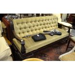 A Victorian button backed and upholstered mahogany framed settle having shaped open arms with