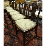 A set of six matched walnut Hepplewhite side chairs having moulded and pierced splats over drop-in