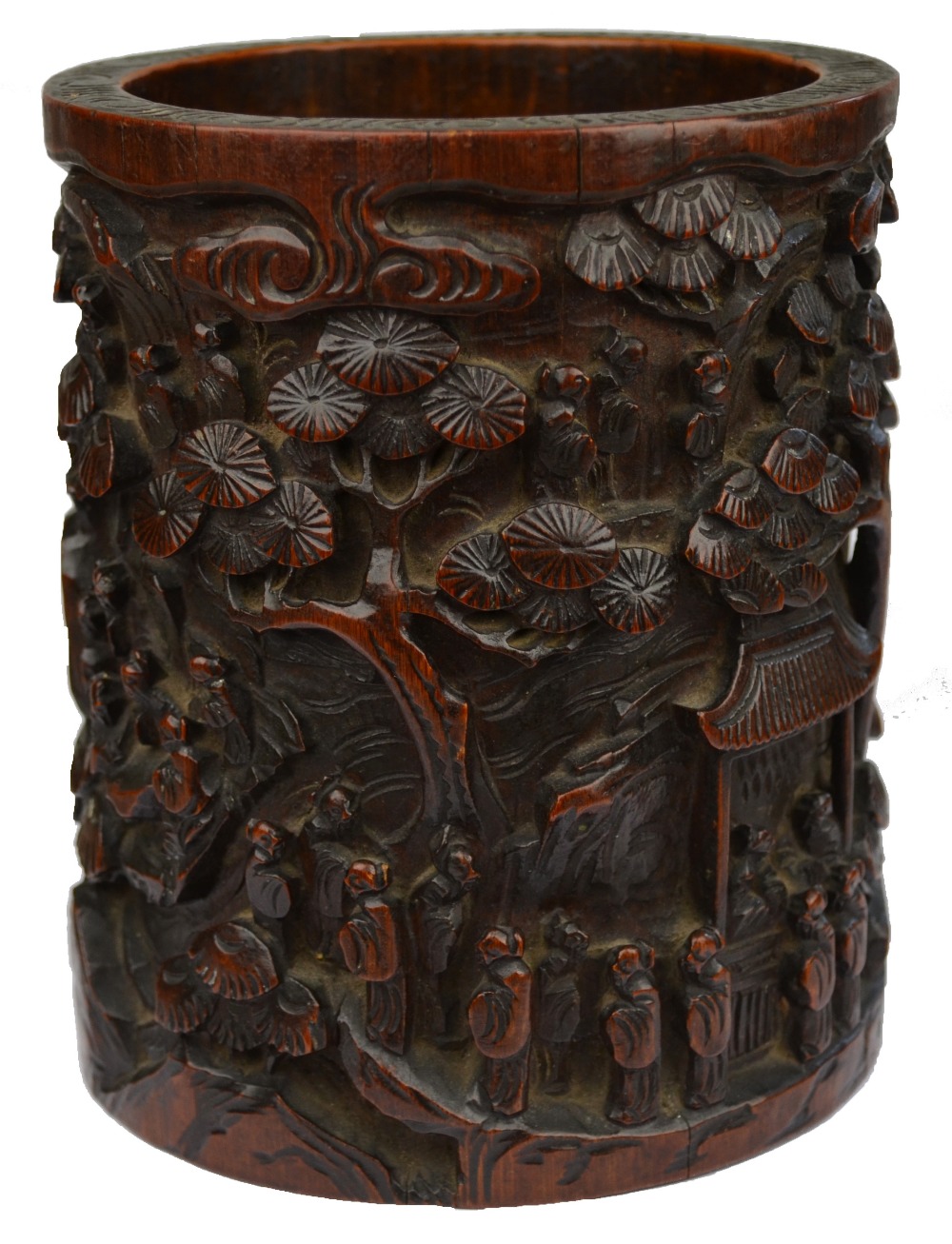 A Chinese bamboo brush pot carved with numerous figures on a mountainous path with buildings and