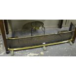 A Regency brass and tin hearth fender with Gothic-pierced grill and scroll and claw feet,