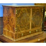 A William & Mary laburnum oyster veneered cabinet having a pair of well figured doors enclosing an