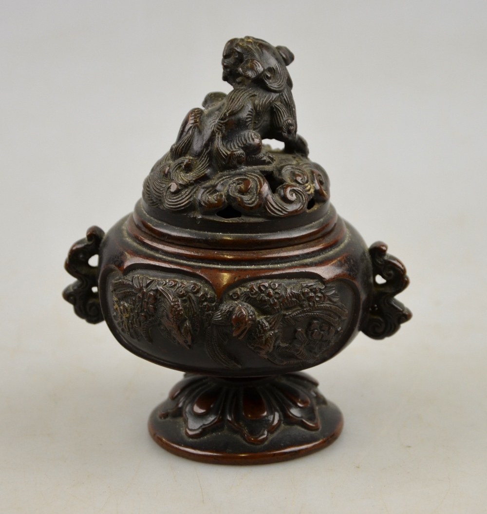 A Japanese bronze incense burner decorated in relief with panels of birds, the reticulated cover - Image 2 of 3