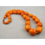 AMENDMENT - WEIGHS APPROX 3 OZ A single row of graduated baroque amber beads knotted throughout onto