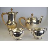 A heavy quality oval four-piece tea service in the Art Deco manner, with composite handles, on bun