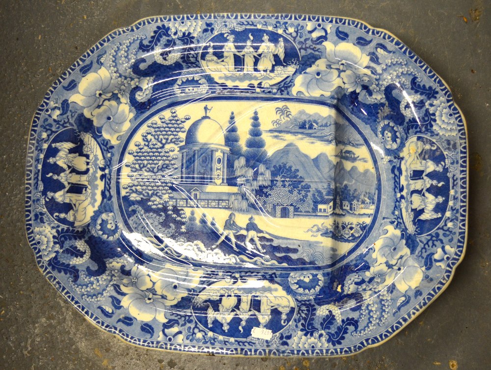 A 19th century blue and white meat plate with gravy well transfer decorated with an Asian/Oriental