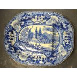 A 19th century blue and white meat plate with gravy well transfer decorated with an Asian/Oriental