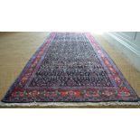 A Persian Senneh long rug, the repeating design on ink blue ground,