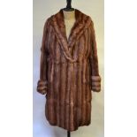 A shadowed musquash fur coat with shawl collar and cuffed sleeves, 53 cm across chest,