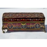 A 19th century Bohemian ruby glass casket with enamelled and gilt decoration, on scrolling brass