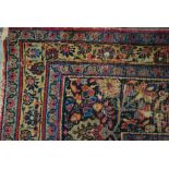 An antique Persian Isphahan/Meshed carpet, the centre floral medallion design on indigo ground, 3.40