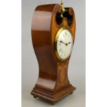 An Edwardian inlaid mahogany balloon-clock with ornate scroll-top and brass finial, drum movement,