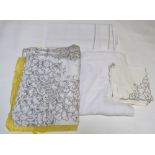 A linen tablecloth with floral embroidered cut-out work and set of matching napkins, another linen