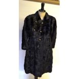 A black mink fitted fur coat with six decorative gilt metal buttons and mandarin collar,