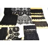 A collection of 19th century and other black lace lengths, veiling, a length of moire silk etc.