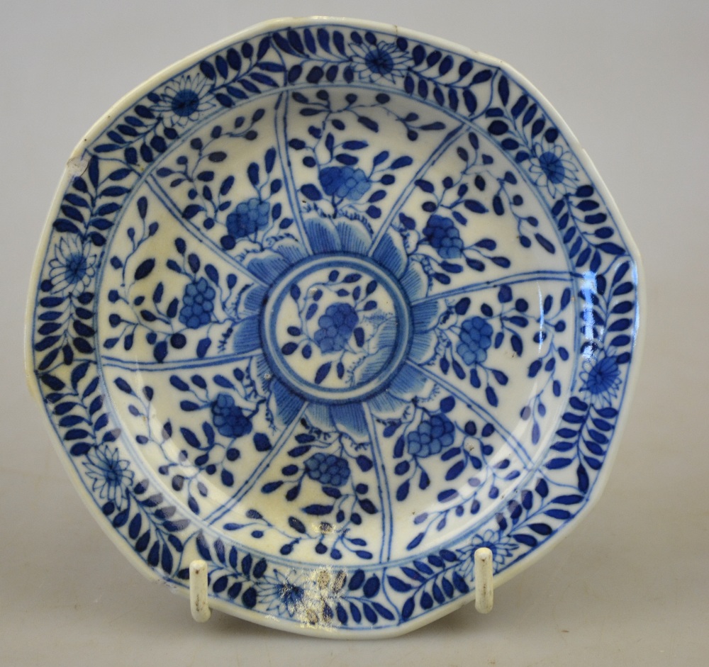 A Chinese blue and white moulded saucer decorated with panels of foliage, Kangxi four character mark