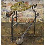 A pierced brass and wrought iron footman to/w a wrought iron metal-smelting ladle (2)