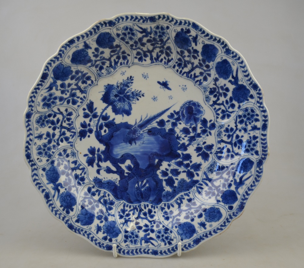 A Chinese blue and white moulded dish decorated with a bird perched on rockwork amidst flowers,