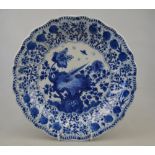 A Chinese blue and white moulded dish decorated with a bird perched on rockwork amidst flowers,