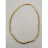 Yellow metal snake style necklace chain on engraved barrel snap,