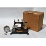 An early 20th century German sewing machine with floral gilt decoration in the Art Nouveau style