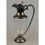 An Edwardian silver small wine ewer with blown glass body and silver collar, cover and handle,