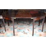 George III mahogany D-end dining table comprising a pair of demi-lune tables each raised on four