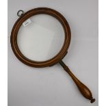 A very large Victorian walnut magnifying glass on turned handle, 26 cm diameter Condition Report