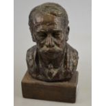 A small bronzed plaster bust of a mustachioed gentleman, signed indistinctly and dated 1930,